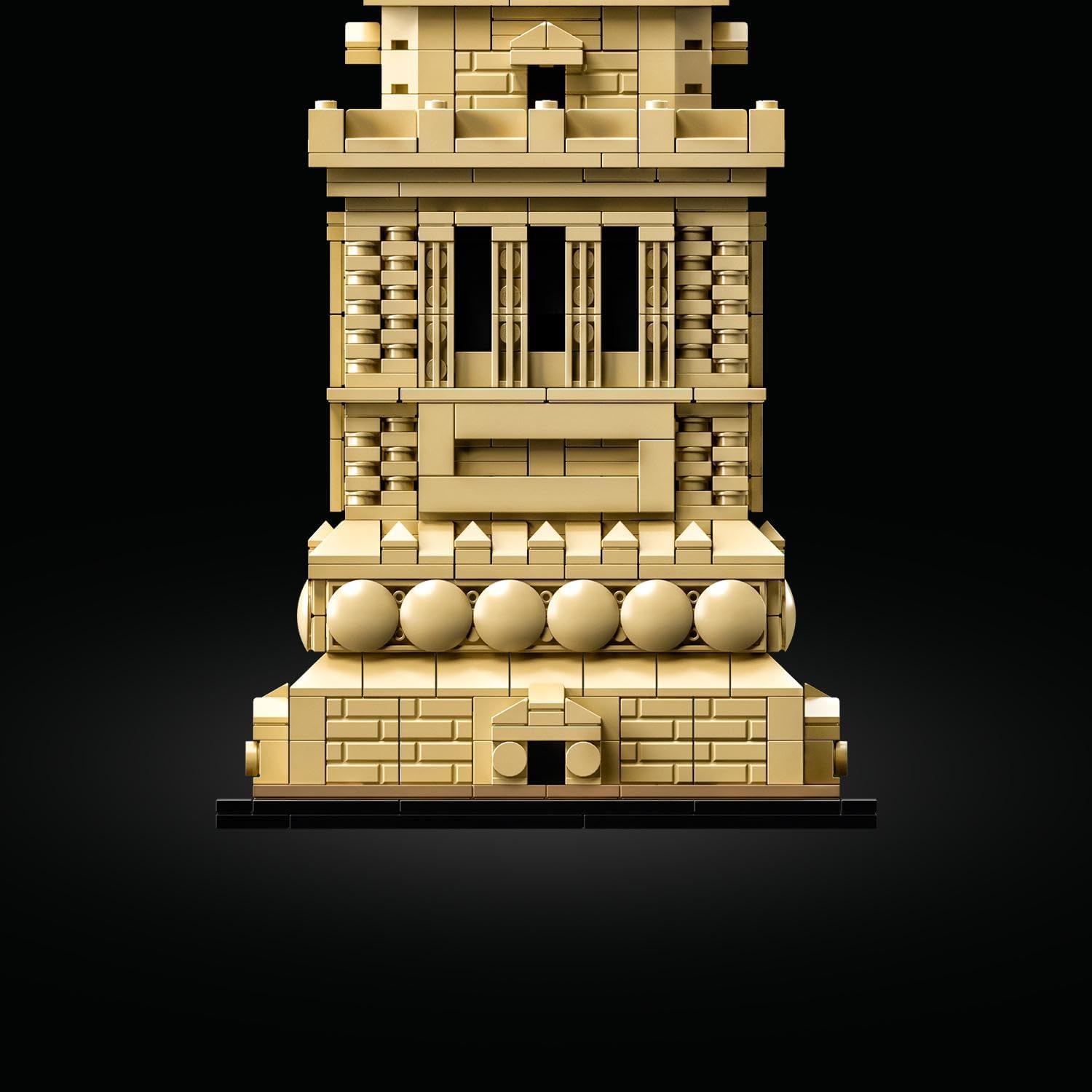 A striking LEGO® Architecture statue model, showcasing stunning details—like the elegantly flowing robe and ornate pedestal. The golden torch glimmers. Set against a pristine white backdrop, it almost feels like it’s ready to spring to life.