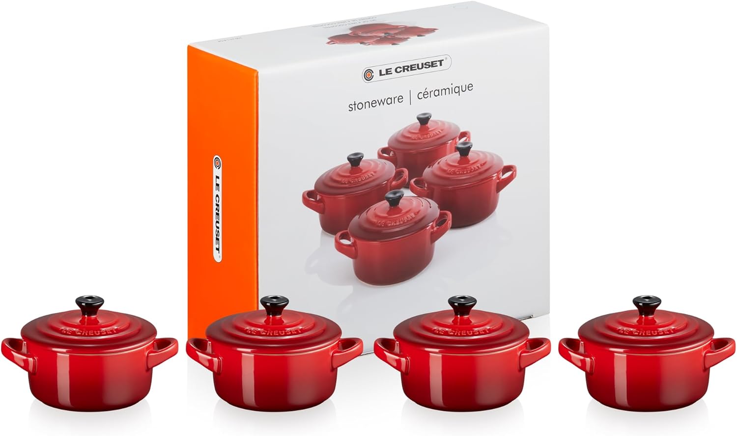 Four Le Creuset mini round casseroles, in a striking azure blue—perfectly adorable. Each holds 250 ml, sitting pretty on a soft, neutral backdrop. Can you imagine the cute little meals?