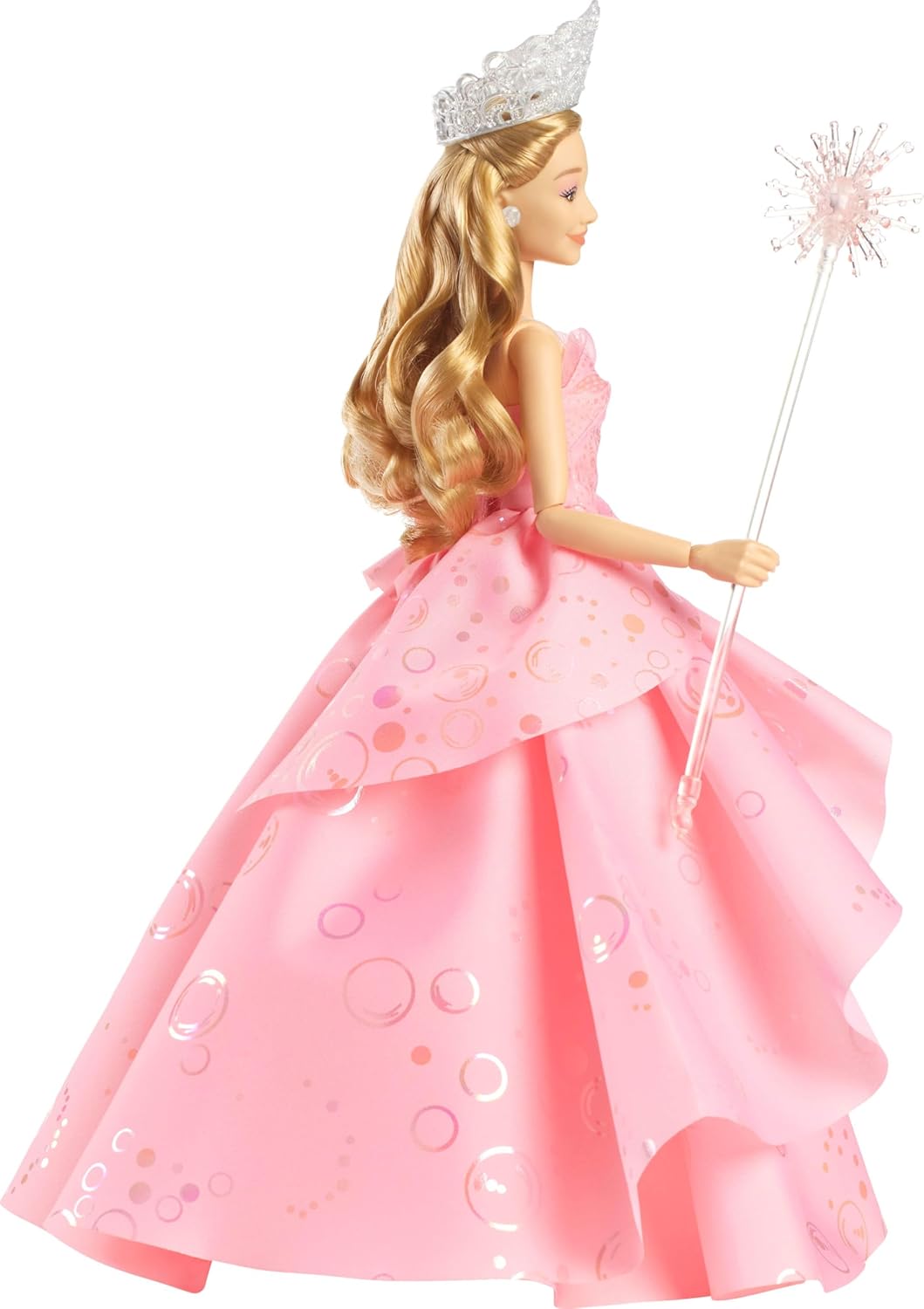 Glinda Deluxe Doll, wow—look at that pink ballgown! It's got ruffles galore and a sparkling tiara perched on her head. She’s even got her wand ready, all set against a simple backdrop. It's like she just stepped out of a fairytale... or your childhood dreams.