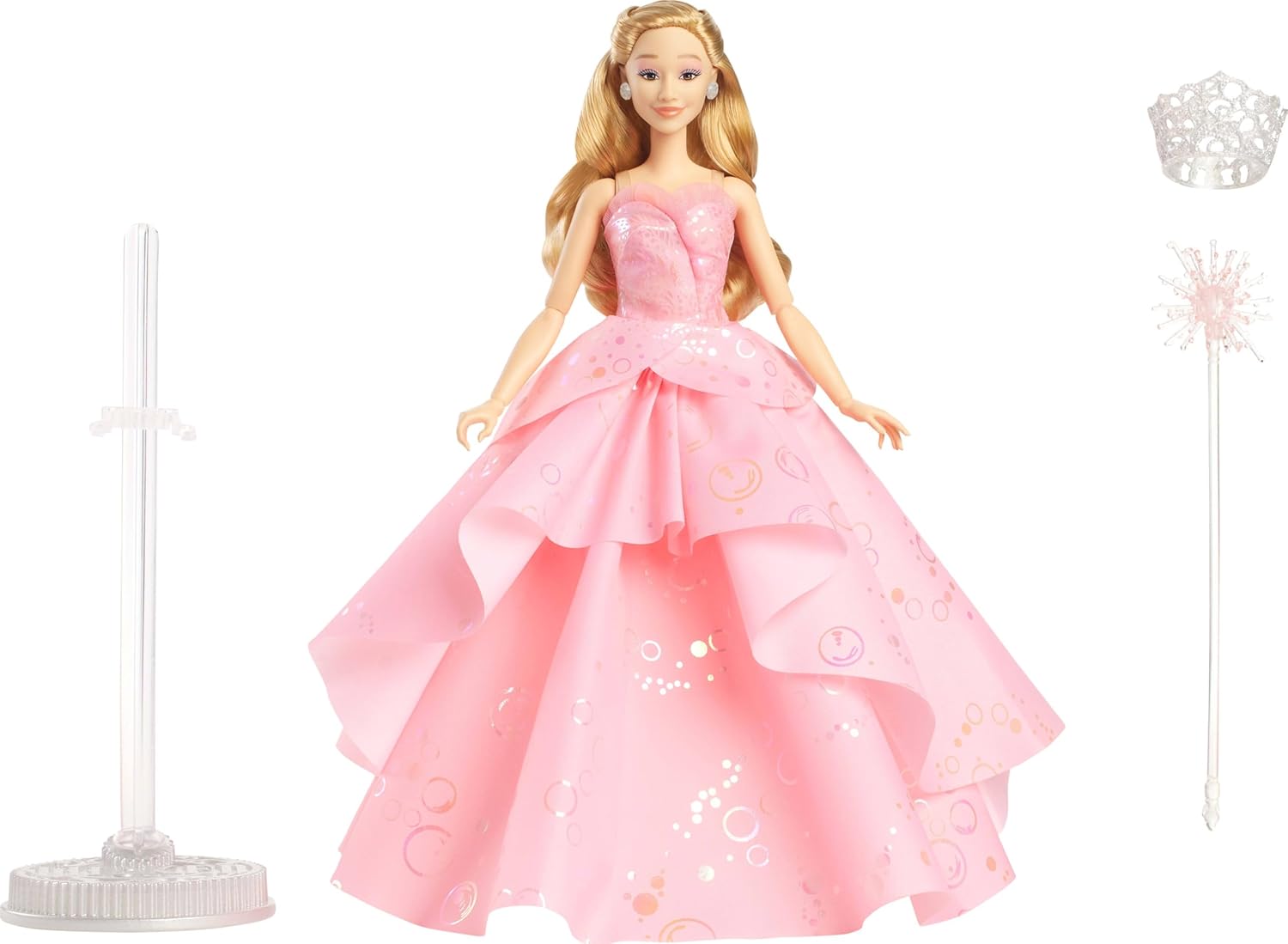 Glinda Deluxe Doll—she’s rocking a huge, fluffy pink ballgown, with all those ruffles that drown you in fairy-tale vibes. She grips a sparkly wand like it’s a secret weapon, and that tiara? Perfection. All set against a clean white backdrop, making her stand out. Just magic.