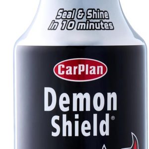 A sleek black Demon Shield car sealant bottle, chilling against a shiny surface—just look at that gleam on the vehicle! It’s like the sealant is saying, “I got you, fam.”
