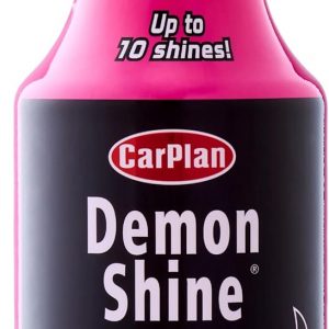 A bottle of Demon Shine car detailing spray—sleek black, shiny, with a striking red cap—sitting on a glossy surface, catching the light just right. Perfect for giving your ride that killer finish.
