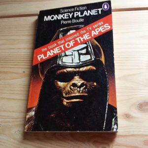 Cover of 'Monkey Planet' by Pierre Boulle—an eye-catching illustration grabs your attention; an ape stands tall, surrounded by a lush jungle. Bold typography shouts from the page—it's vivid, almost demanding a second look. The whole vibe? Wild, untamed, and a bit mysterious. Definitely not your standard sci-fi fare.
