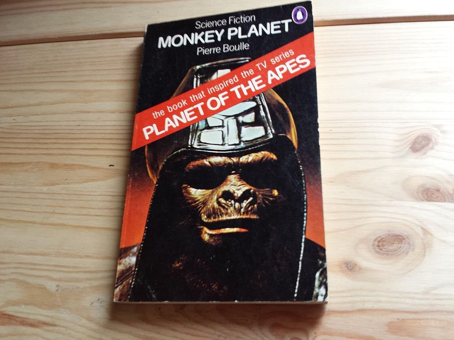 Cover of 'Monkey Planet' by Pierre Boulle—an eye-catching illustration grabs your attention; an ape stands tall, surrounded by a lush jungle. Bold typography shouts from the page—it's vivid, almost demanding a second look. The whole vibe? Wild, untamed, and a bit mysterious. Definitely not your standard sci-fi fare.