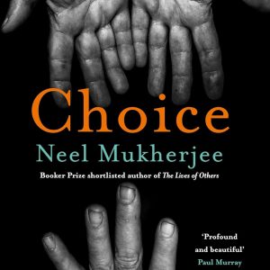 A striking blue Mukherjee Neel bottle, its label all ornate and eye-catching, sits on a rustic wooden table—like it’s just waiting to tell a story.